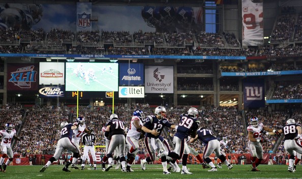 Brady (12) handing the ball to Laurence Maroney (39) in Super Bowl XLII. 